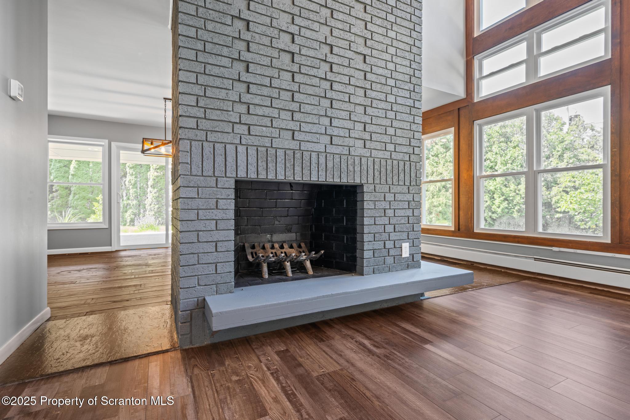 2001 Cleveland Avenue Scranton, PA 18505 - Photo 21 of 87 a living room with a fireplace wooden floor and a large window