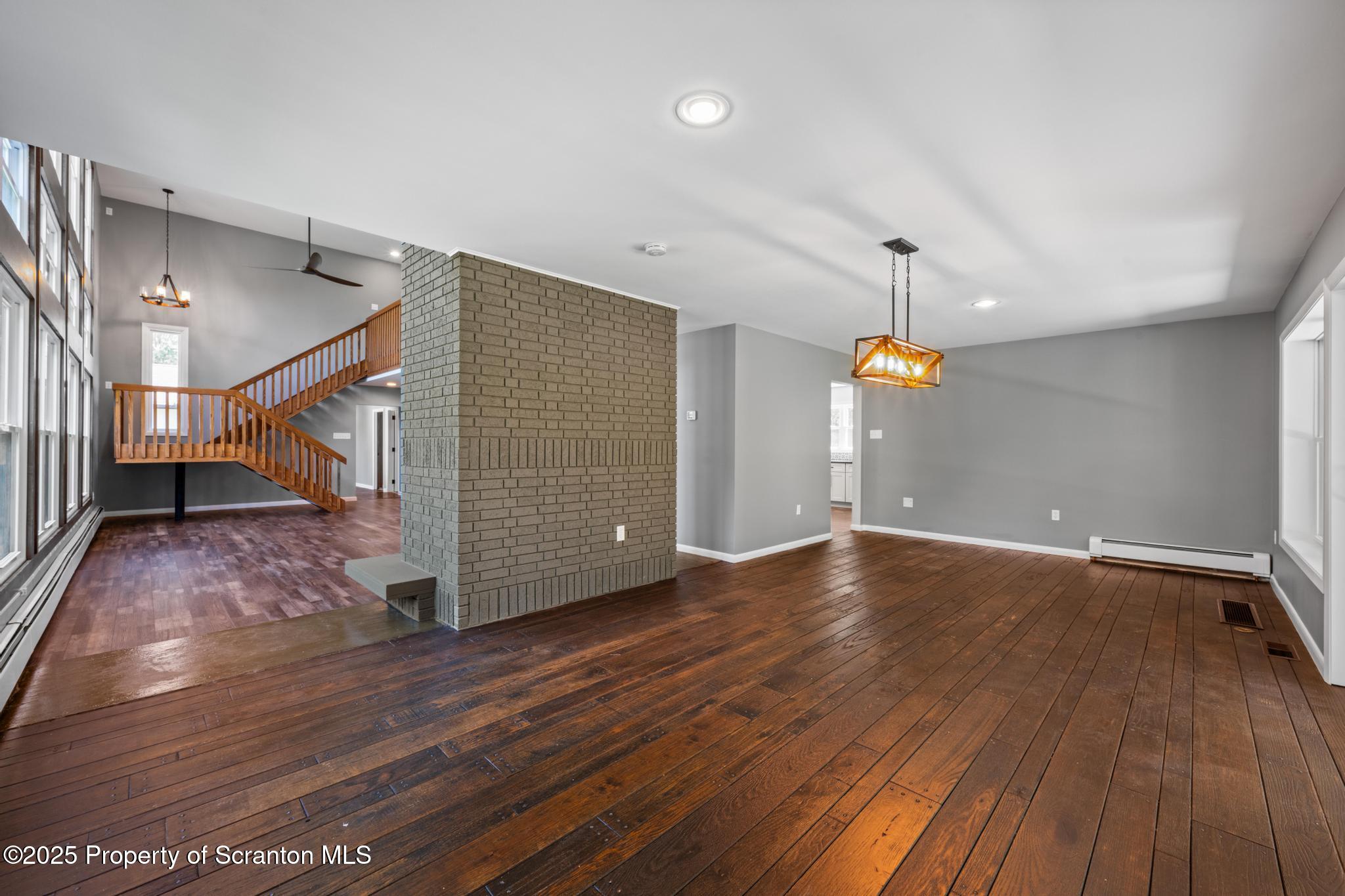 2001 Cleveland Avenue Scranton, PA 18505 - Photo 23 of 87 a view of an empty room with wooden floor stairs and a chandelier