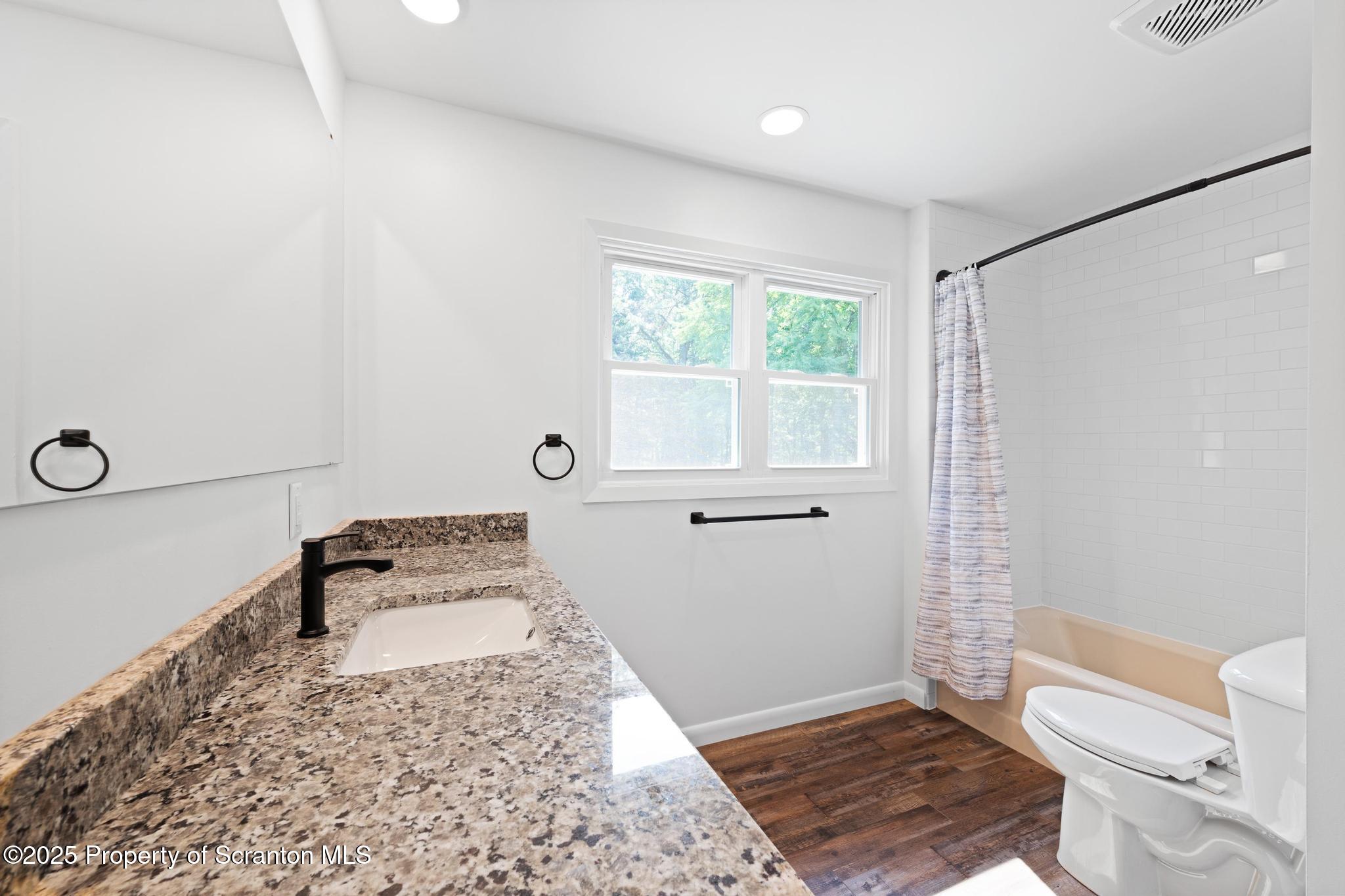 2001 Cleveland Avenue Scranton, PA 18505 - Photo 39 of 87 a bathroom with a toilet a sink and a window