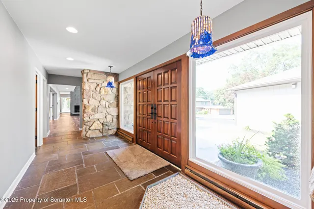 a view of a kitchen with furniture a fireplace and wooden floor