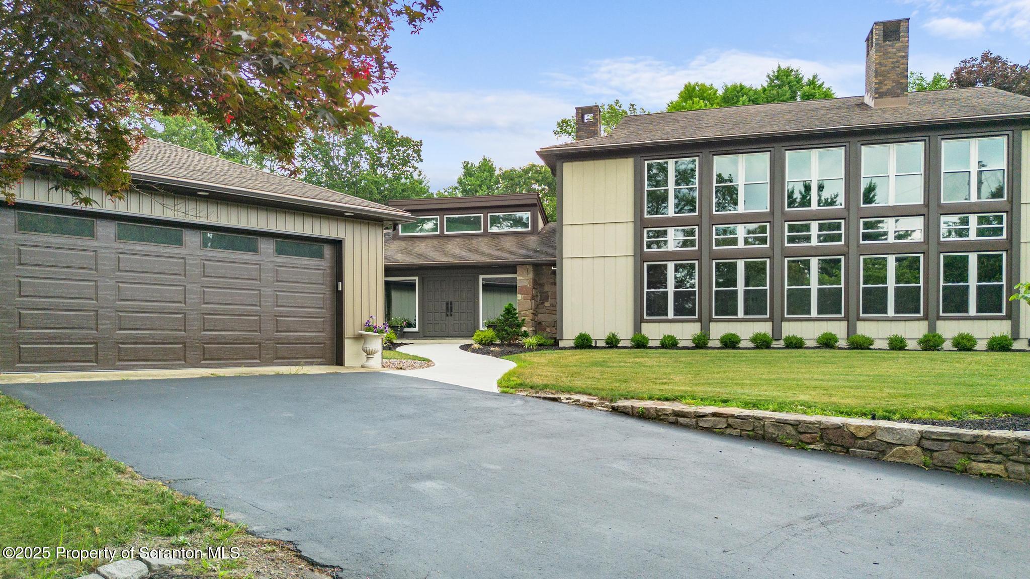 2001 Cleveland Avenue Scranton, PA 18505 - Photo 79 of 87 a front view of a house with a yard and garage