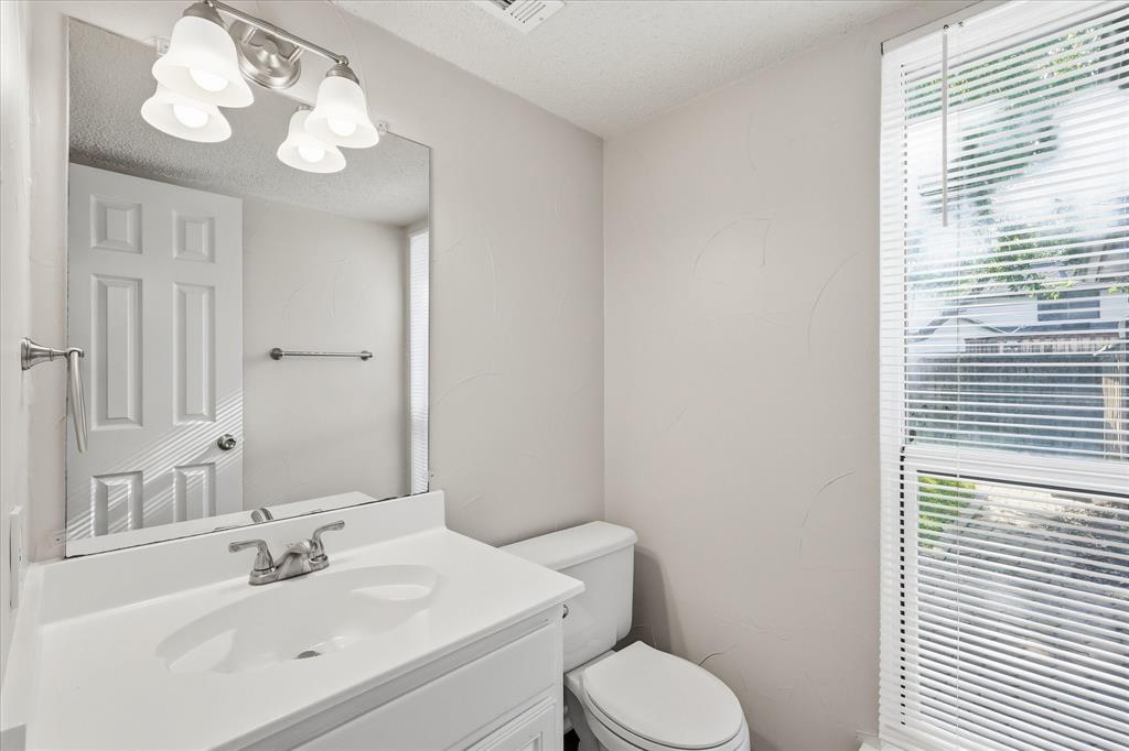 318 Lodge Road Coppell, TX 75019 - Photo 12 of 35 A conveniently located powder bath offers a bright vanity area and natural light for guests.