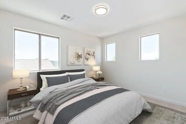 a bedroom with a large bed and a window