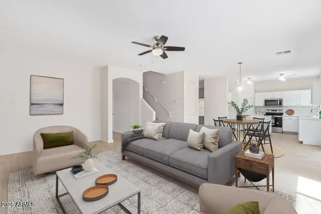 a living room with furniture and a view of kitchen