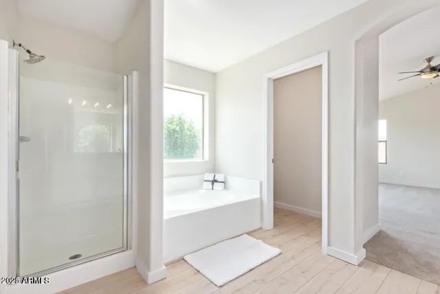 a bathroom with a bathtub a sink and a mirror