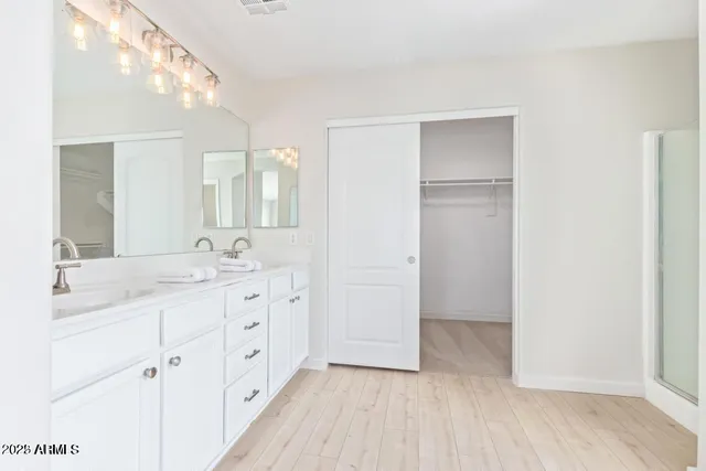 a bathroom with a double vanity sink and mirror