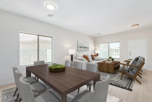 a living room with furniture a table and a large window