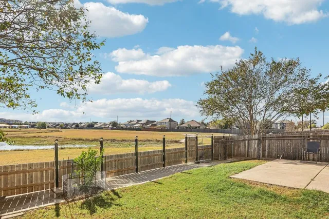 a living room with furniture floor to ceiling window and wooden floor