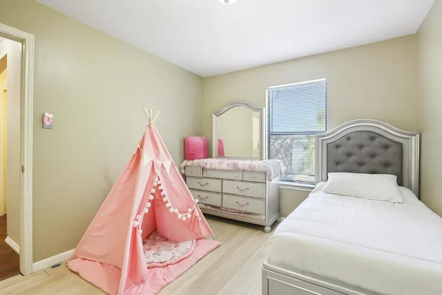 a bedroom with furniture and a window