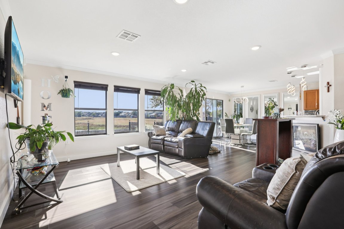 6605 Quinton Drive Austin, TX 78747 - Photo 2 of 19 a living room with furniture floor to ceiling window and wooden floor