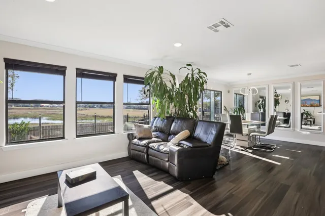 a living room with furniture kitchen view and a table