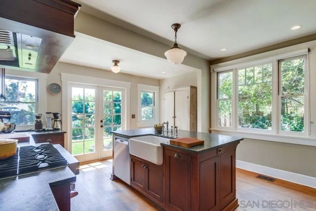 a living room with large windows with wooden floor