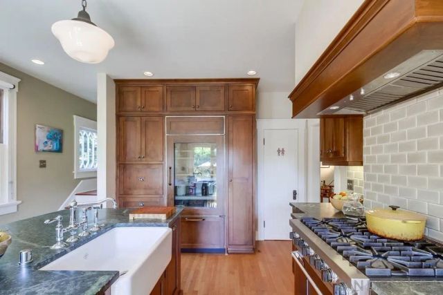 a bathroom with a granite countertop sink a mirror and vanity