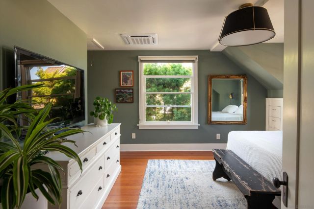 a bedroom with a bed and a large window