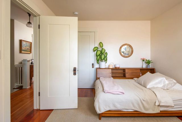 a bedroom with a bed and a window