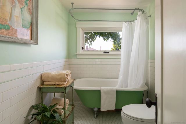 a bathroom with a toilet and a bathtub