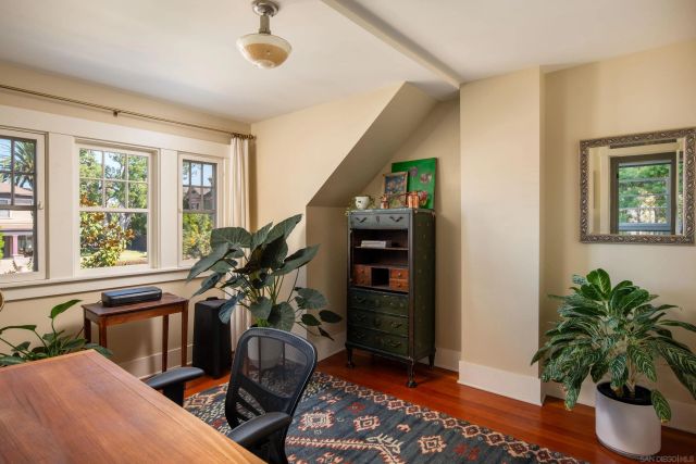a living room with furniture and potted plant