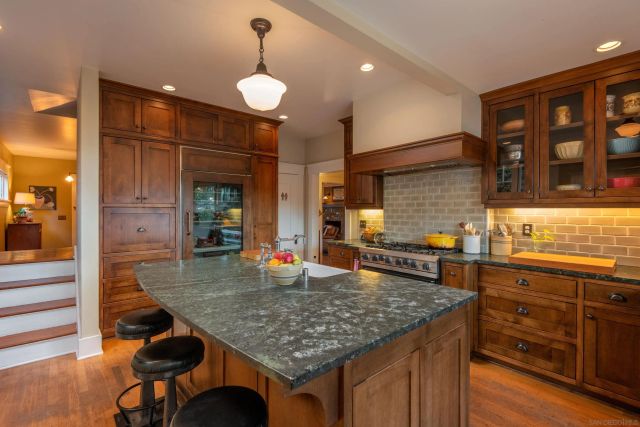 a kitchen with stainless steel appliances granite countertop a stove and cabinets