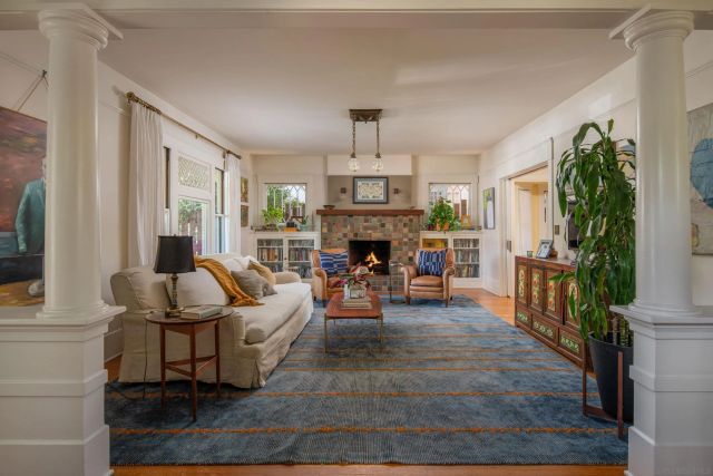 a living room with furniture and a fireplace