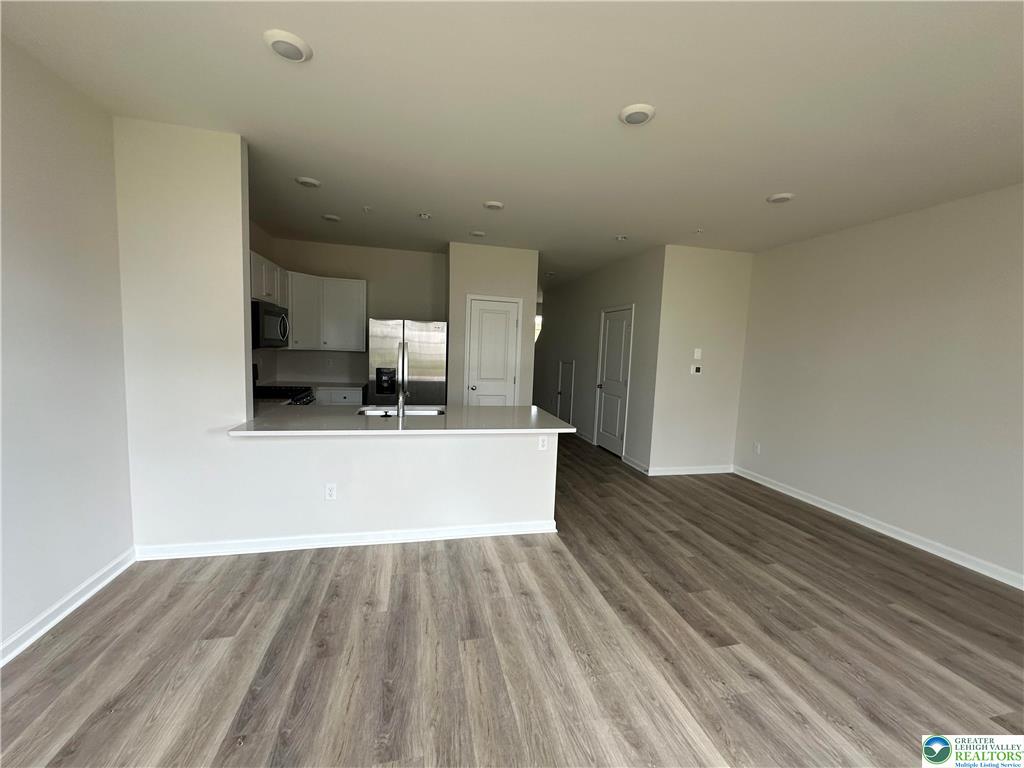 1145 Martin Road Breinigsville, PA 18031 - Photo 24 of 38 A well-lit, open-concept living area with a contemporary kitchen, perfect for modern living.