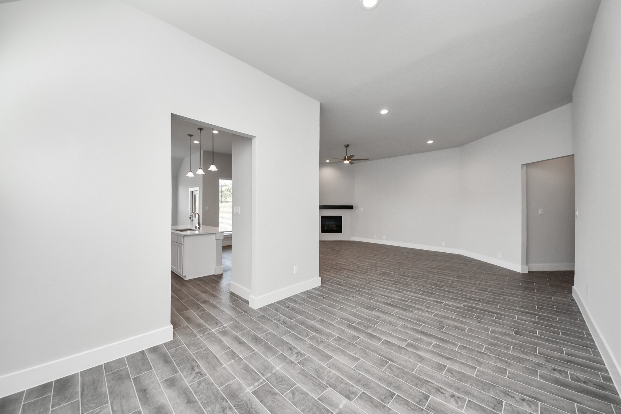 3121 Skerne Spring Dr Spring Spring, TX 77373 - Photo 16 of 44 Craft enduring memories with loved ones around the table! This roomy dining area boasts stylish flooring, personalized paint, and is conveniently situated next to the family room and kitchen, fostering an open and inclusive ambiance.