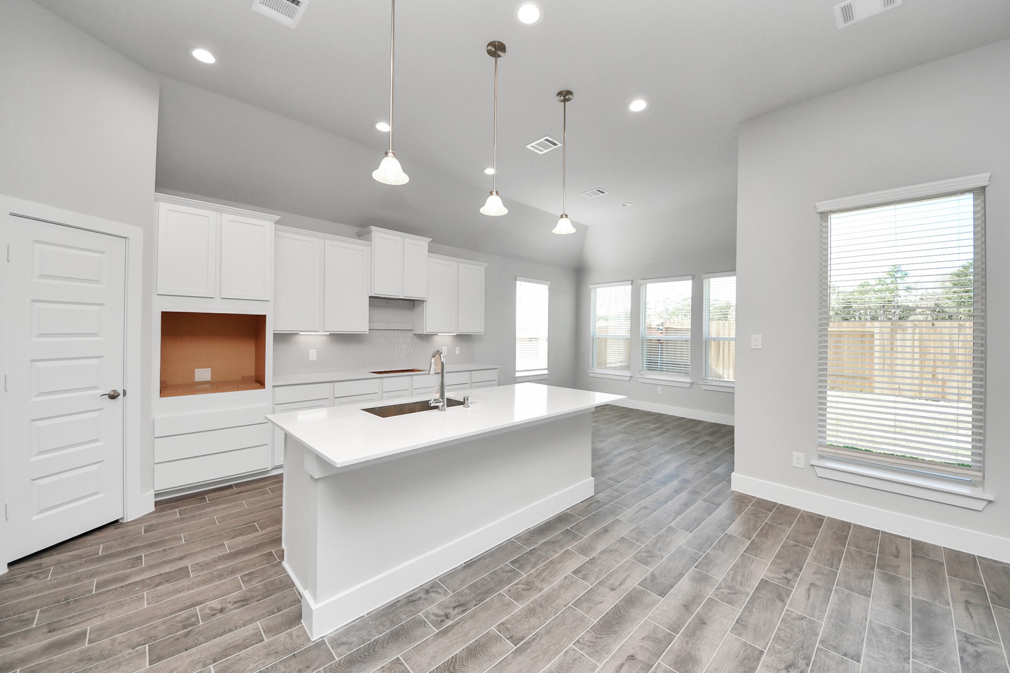 3121 Skerne Spring Dr Spring Spring, TX 77373 - Photo 19 of 44 The extended counter area adds both practicality and style, making meal preparation a breeze. Every detail is thoughtfully designed to enhance the kitchen's functionality and aesthetic appeal.