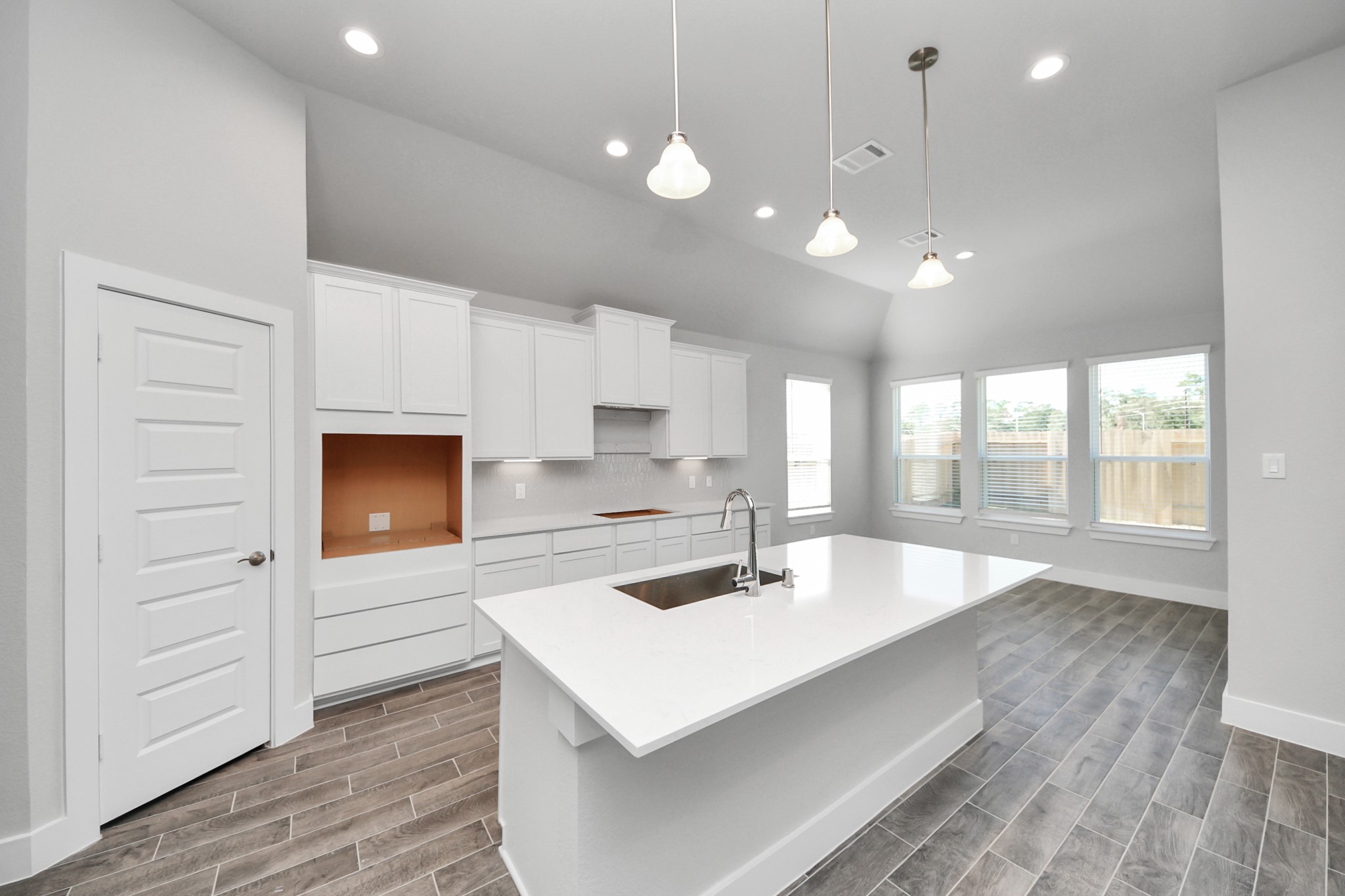 3121 Skerne Spring Dr Spring Spring, TX 77373 - Photo 20 of 44 The open concept effortlessly connects the kitchen to the expansive family room, forming a perfect hub for gatherings. This seamless flow creates an inviting space where cooking and socializing come together harmoniously.