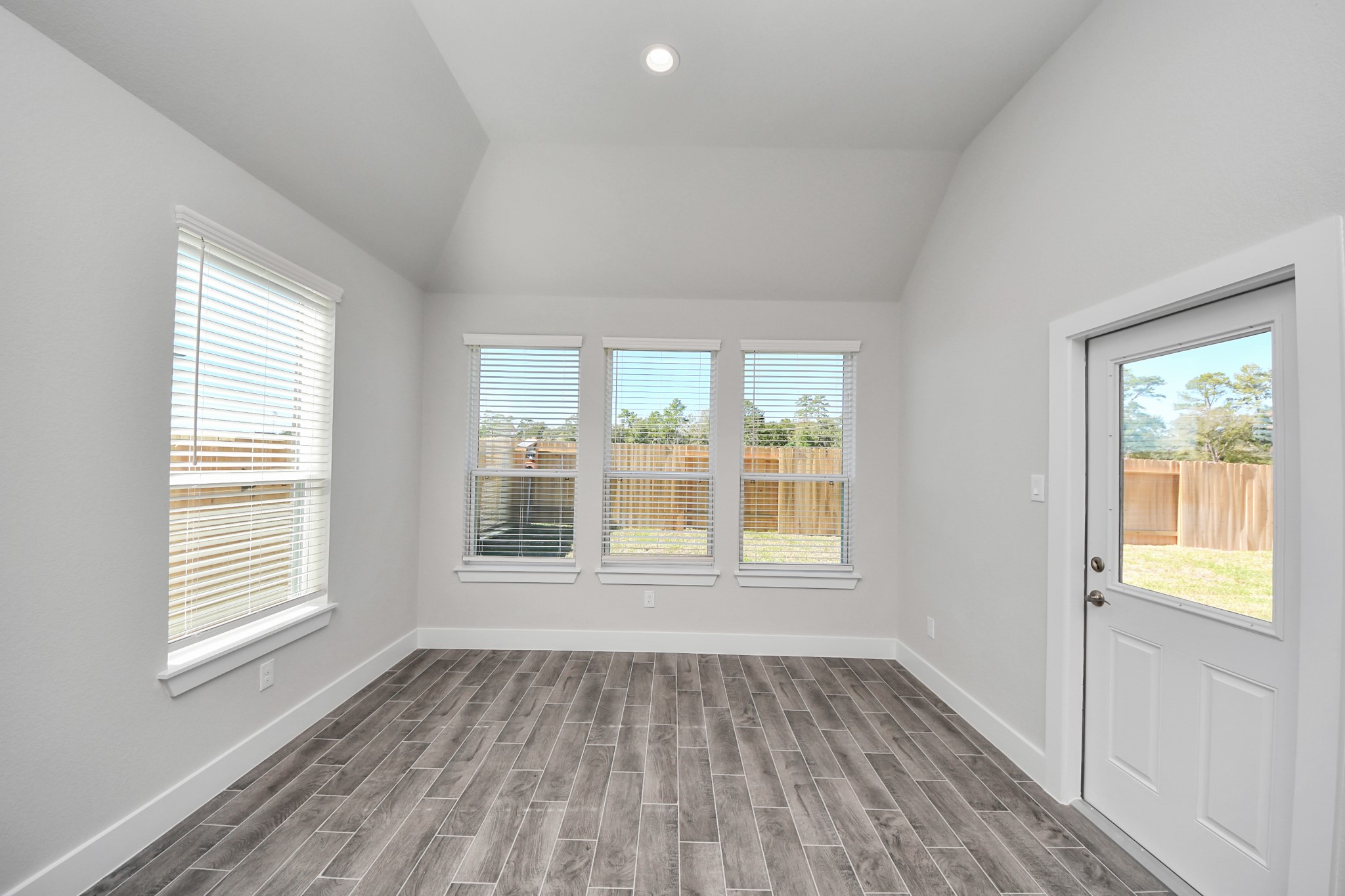 3121 Skerne Spring Dr Spring Spring, TX 77373 - Photo 24 of 44 Enjoy breakfast with ease in the connected and cozy breakfast area, seamlessly integrated with the kitchen for utmost convenience. Step through the back door for a breath of fresh air onto the covered patio, extending your living space to the outdoors.