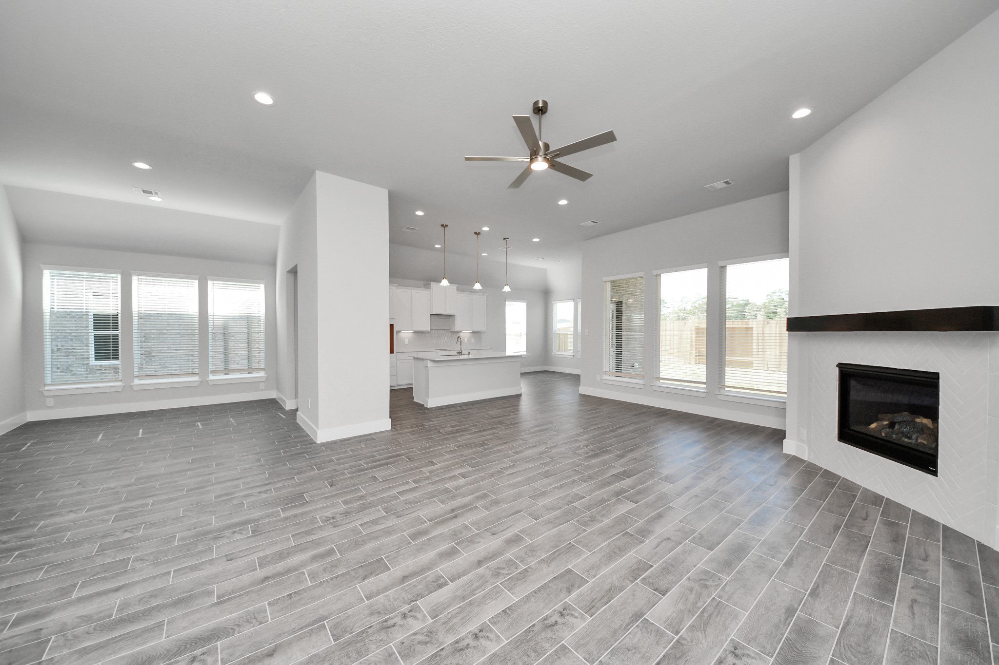 3121 Skerne Spring Dr Spring Spring, TX 77373 - Photo 25 of 44 Welcome family and guests to your charming living room! With its high ceilings, recessed lighting, ceiling fan, custom paint, beautiful flooring, and large windows that let in abundant natural light, this room is perfect for gatherings.