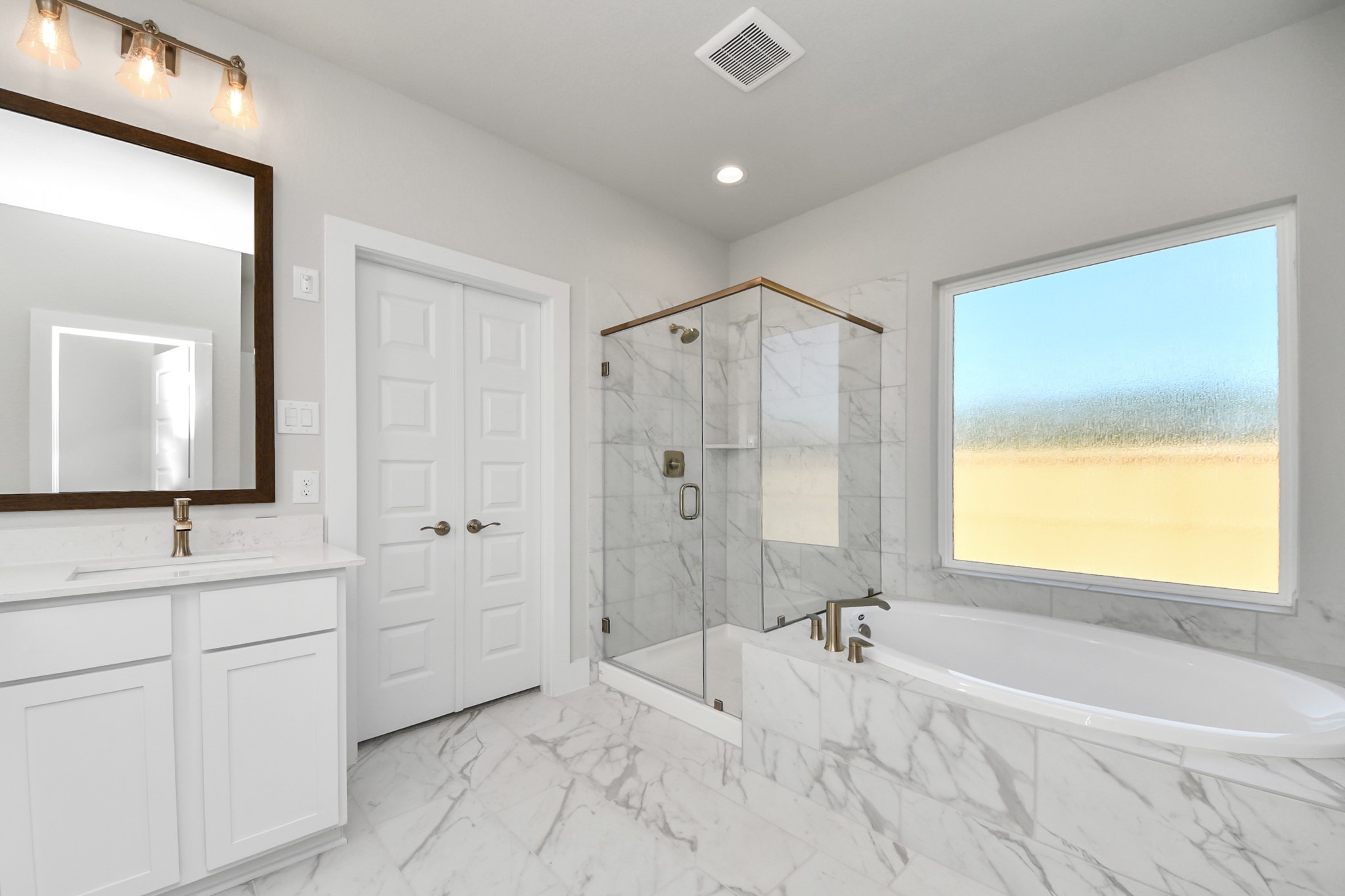 3121 Skerne Spring Dr Spring Spring, TX 77373 - Photo 34 of 44 Indulge in a spa-like retreat within the confines of this primary bathroom. Delight in a spacious walk-in shower enveloped in stylish tile surround and unwind in a separate garden tub adorned with custom detailing.