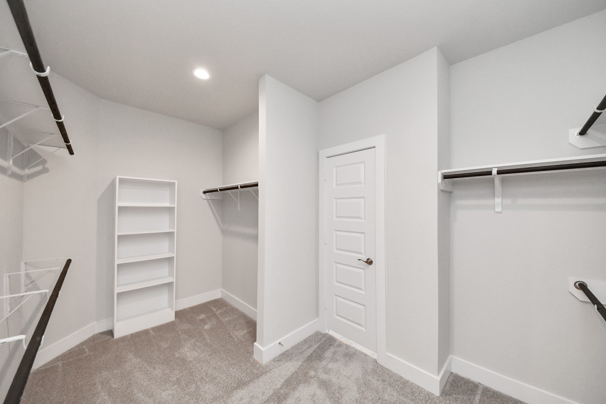 3121 Skerne Spring Dr Spring Spring, TX 77373 - Photo 36 of 44 Walk-in closet that epitomizes luxury and practicality. This generously sized space features built-in shelving, offering abundant room for impeccable organization. High ceilings and recessed lighting create a bright and welcoming ambiance.