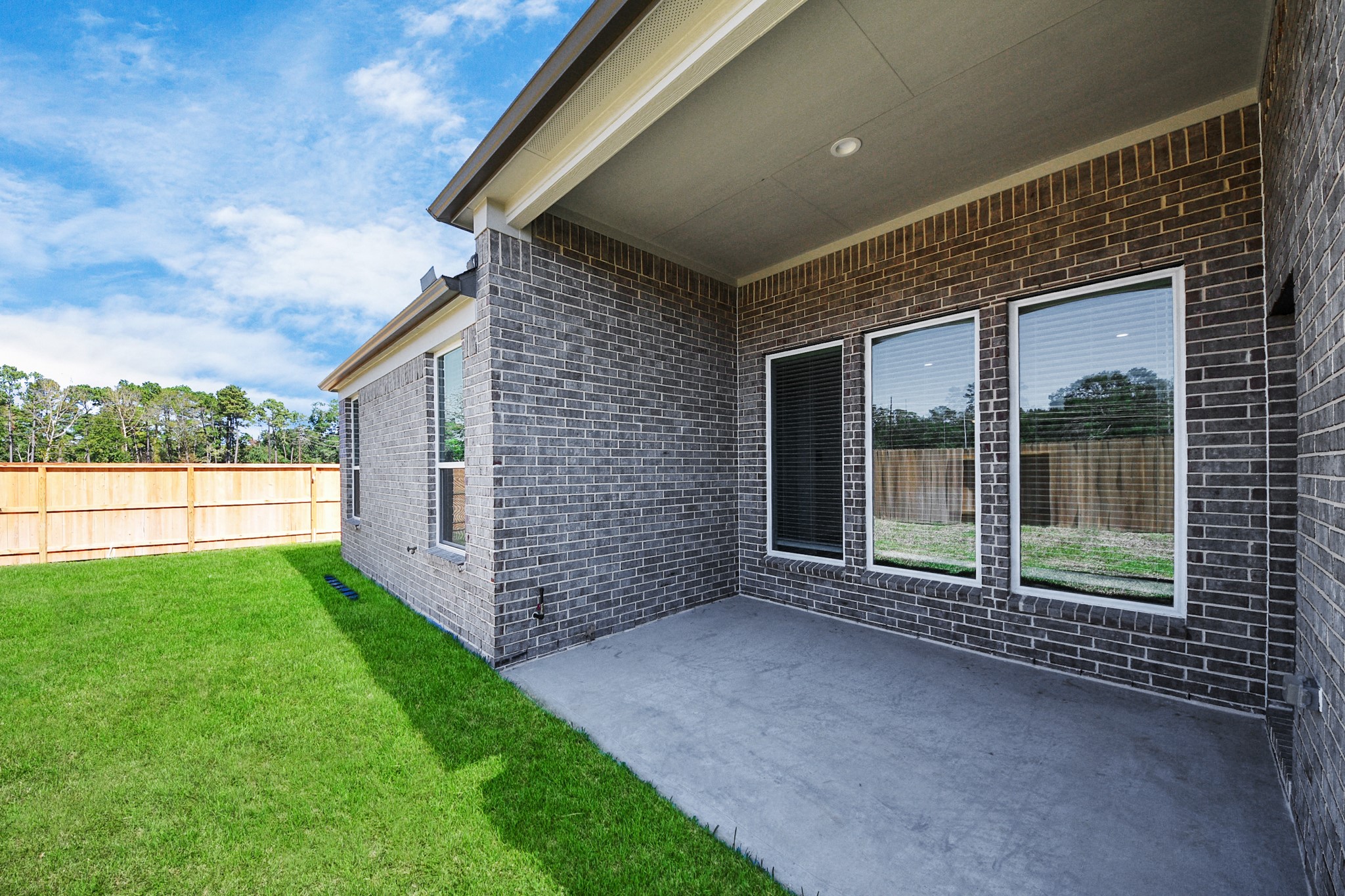 3121 Skerne Spring Dr Spring Spring, TX 77373 - Photo 38 of 44 Experience outdoor living at its finest on this expansive covered patio, thoughtfully designed for BBQs and delightful outdoor dining.