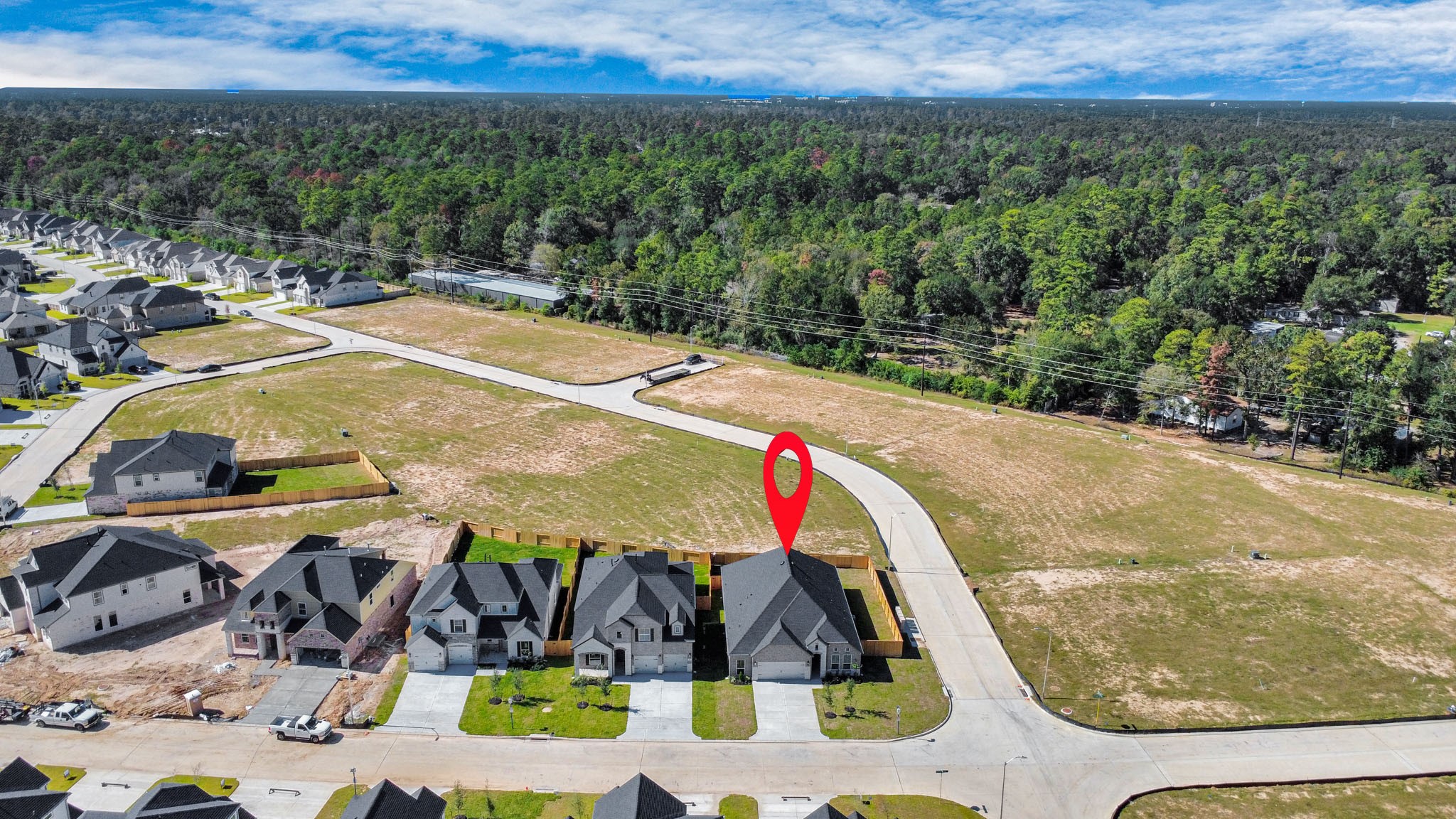 3121 Skerne Spring Dr Spring Spring, TX 77373 - Photo 4 of 44 An aerial view of a spacious subdivision lot, highlighting a well-maintained yard and a fully fenced perimeter, offering both privacy and expansive outdoor space.
