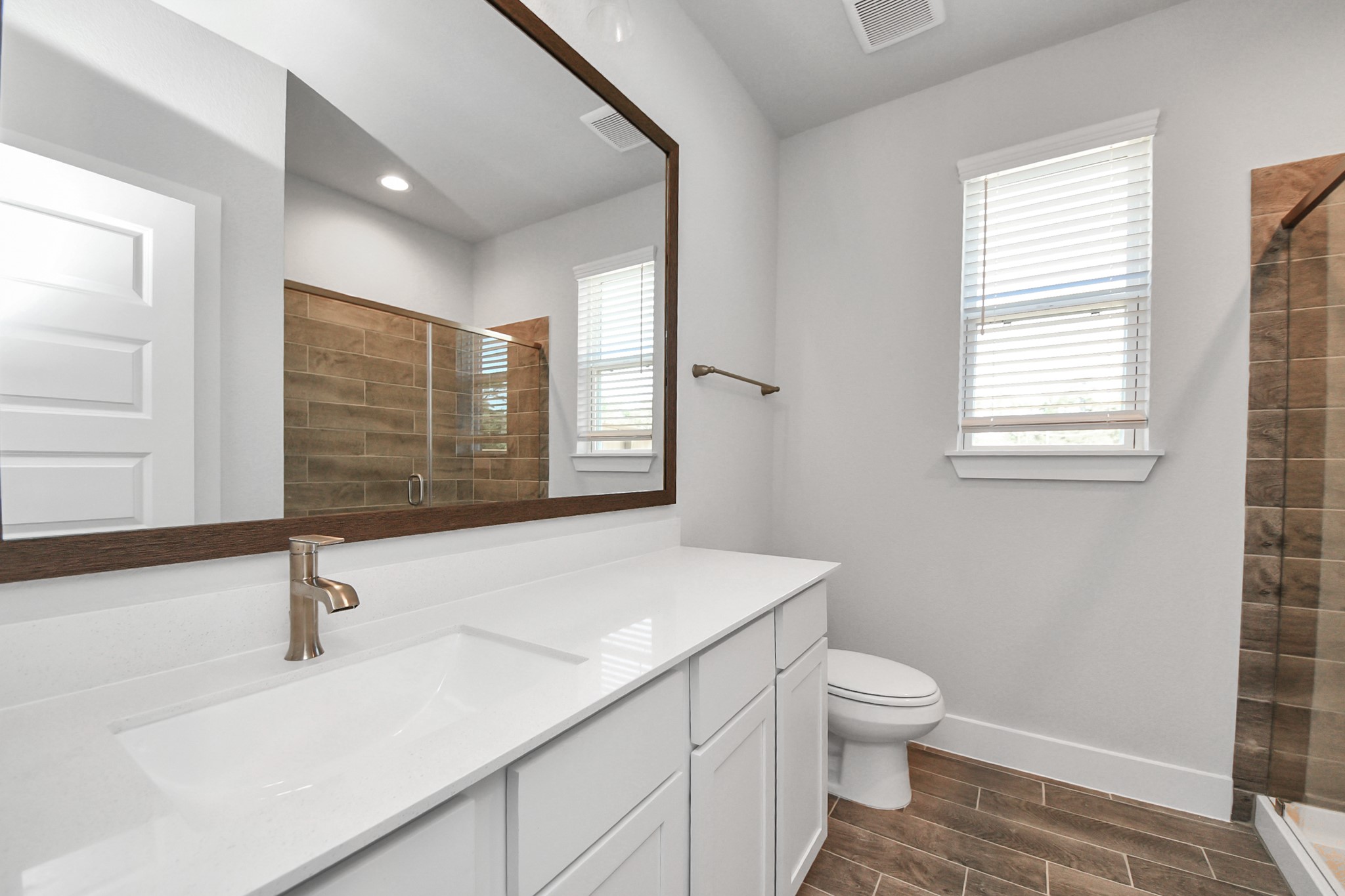 3121 Skerne Spring Dr Spring Spring, TX 77373 - Photo 9 of 44 Secondary bath features tile flooring, walk-in shower with tile surround, light stained wood cabinets, beautiful light countertop.