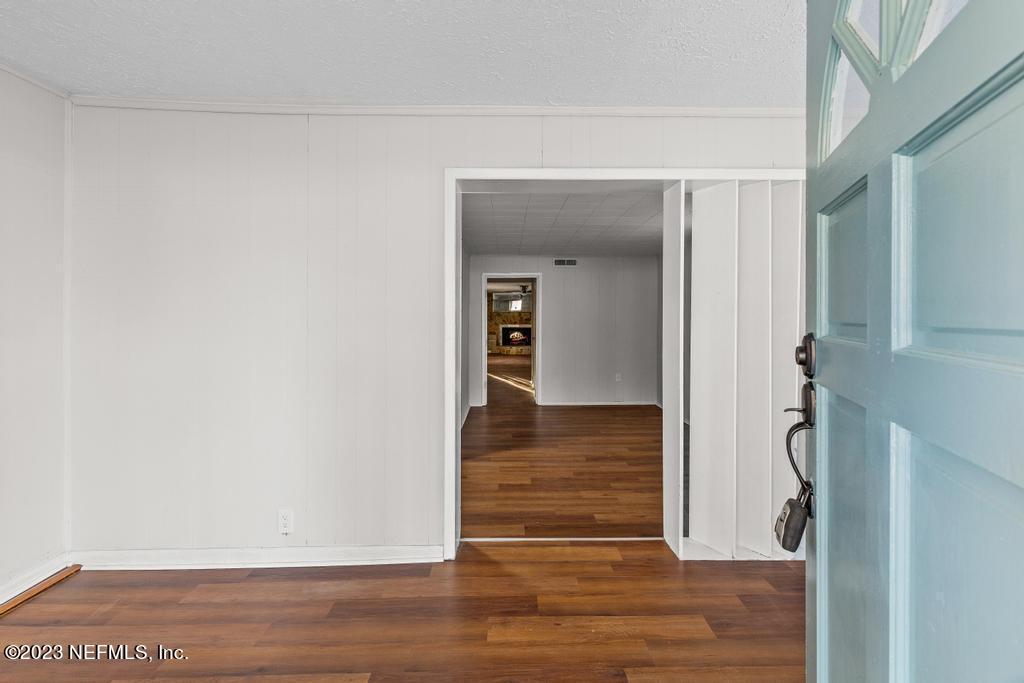 3616 Freeman Road Jacksonville, FL 32207 - Photo 13 of 41 a view of a hallway with wooden floor and staircase