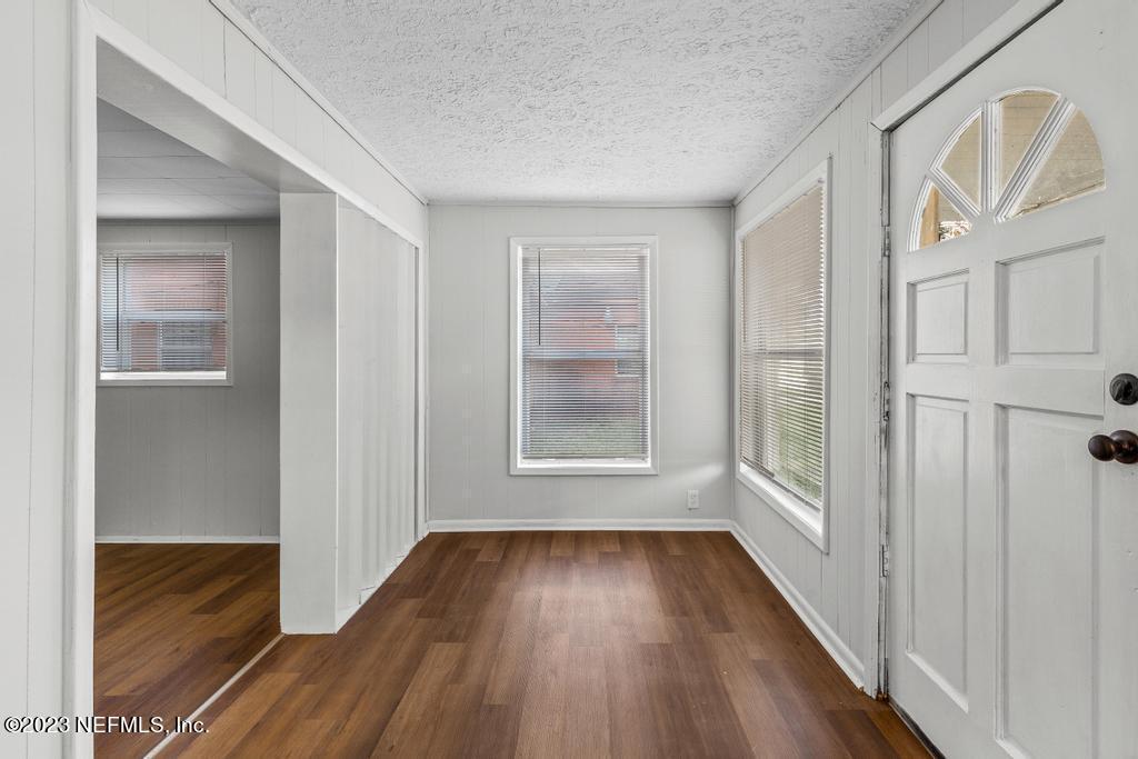 3616 Freeman Road Jacksonville, FL 32207 - Photo 15 of 41 a view of an empty room with wooden floor and a window