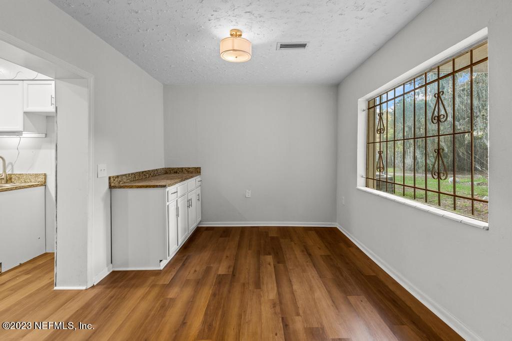3616 Freeman Road Jacksonville, FL 32207 - Photo 23 of 41 a view of empty room with wooden floor and fan