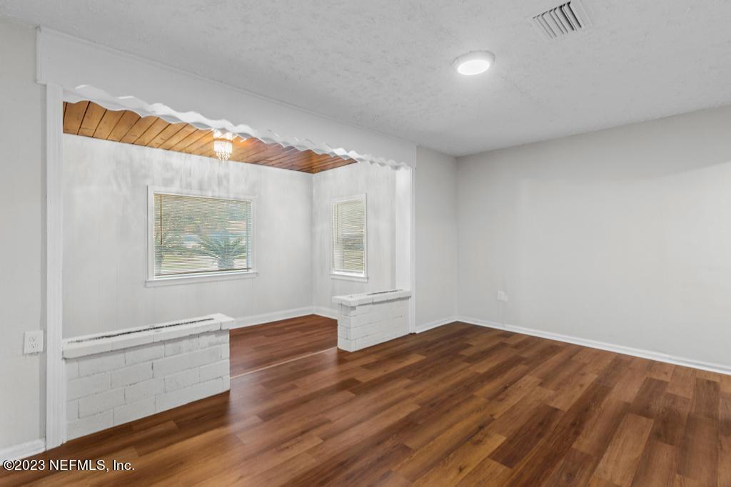 3616 Freeman Road Jacksonville, FL 32207 - Photo 27 of 41 a view of empty room with wooden floor and fan