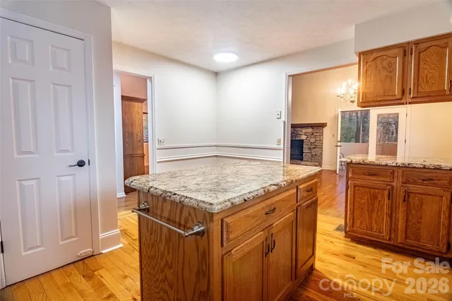 a kitchen with stainless steel appliances granite countertop a stove and a refrigerator
