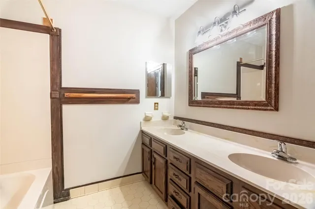 a bathroom with a double vanity sink and mirror