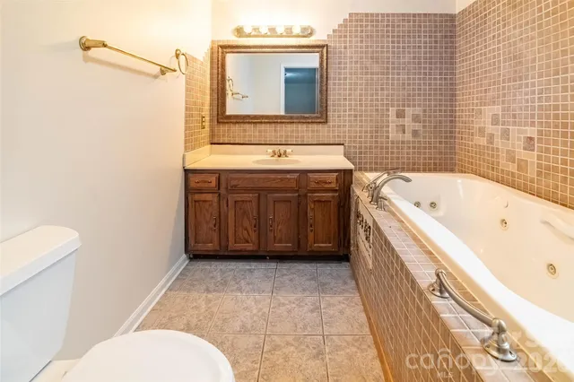 a bathroom with a bathtub and next to a window