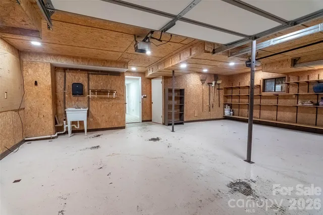 a view of staircase with railing and white walls