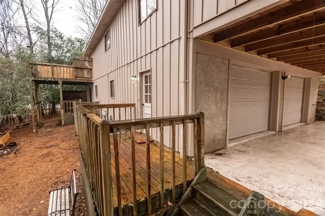 a view of a white house with a yard and plants
