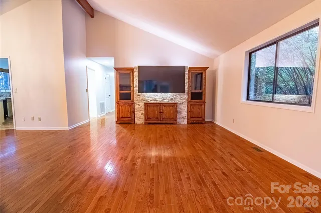 a view of a room with wooden floor and a window