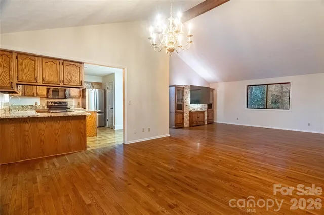 a view of a kitchen with a sink and a refrigerator