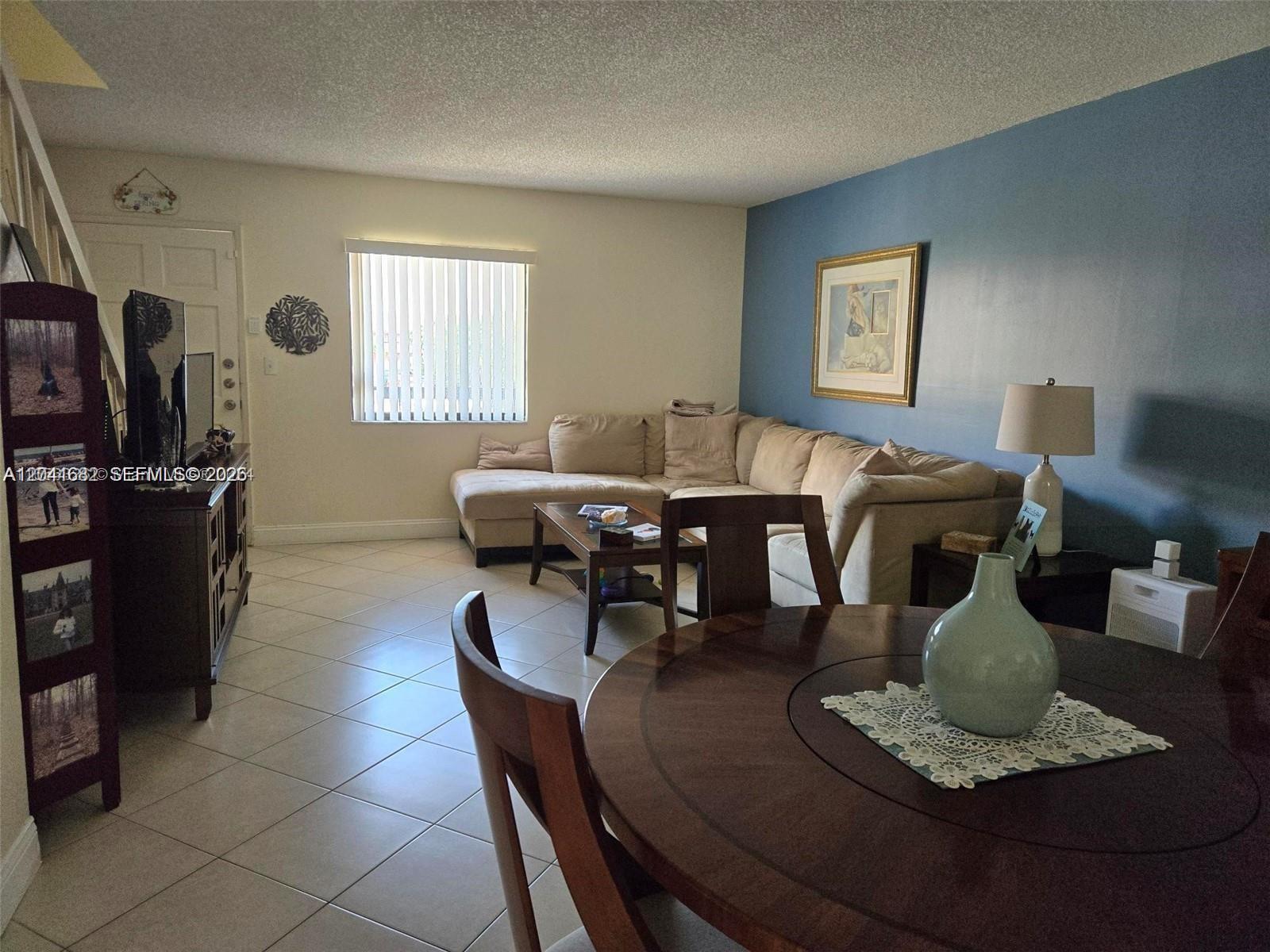 2174 West 60th Street, Unit 17205 Hialeah, FL 33016 - Photo 3 of 11 a living room with furniture and a window