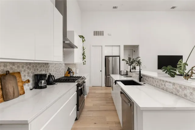 a kitchen with a refrigerator and a counter top space