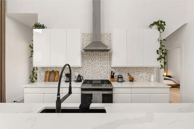 a kitchen with a stove and a white cabinet