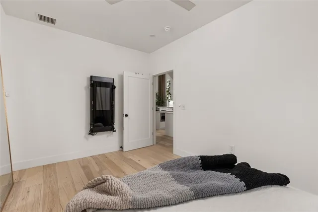 a bedroom with a bed and mirror