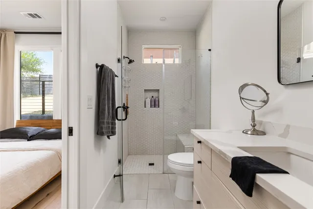 a bathroom with a sink toilet and shower